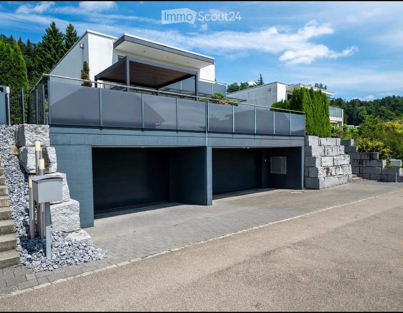 House with double garage, balcony with canopy, grey stone wall, modern architecture