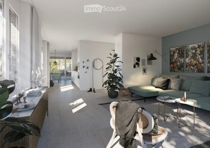 Modern living room with a grey sofa, coffee table, white chair with a blanket, floor lamp, round mirror, large plant, and decorative candles on a side table.