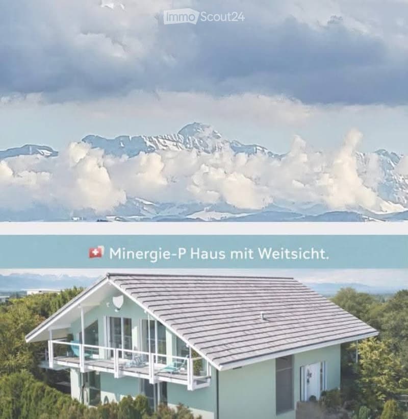 Modern house with a grey roof and light blue walls, surrounded by greenery, with a scenic mountain view in the background.