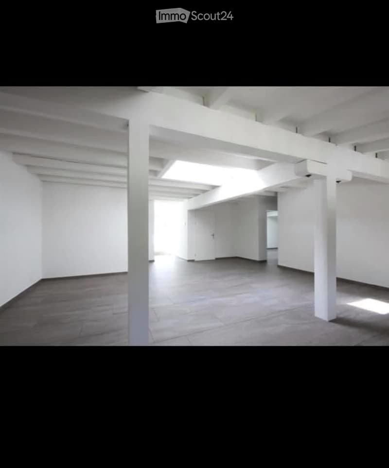 Empty room with white walls, tiled floor, and white structural columns. No furniture or equipment present.