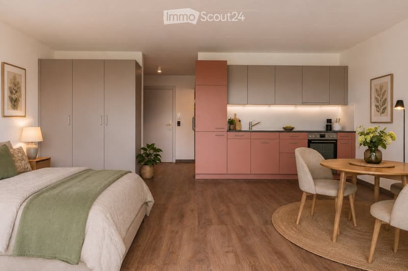 A modern, open-plan living space featuring a bedroom area with a bed, a kitchen area with cabinets and appliances, and a dining area with a table and chairs. The room has wooden flooring, neutral-colored walls, and contemporary decor including framed artw