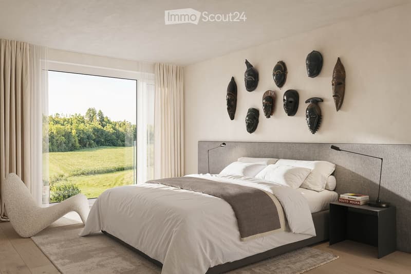 modern styled bedroom with gray walls, wooden floor, glass wall with view of grassy field, gray bed, white and gray bedspread, night tables with lamps, decorative masks on the wall