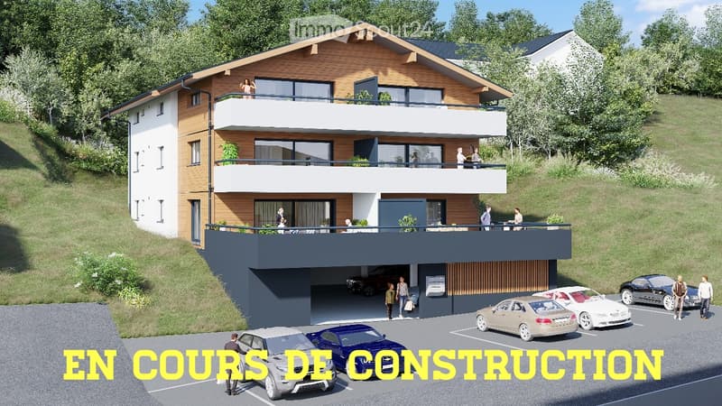 Modern two-story house under construction with balconies, garage, and parking area.