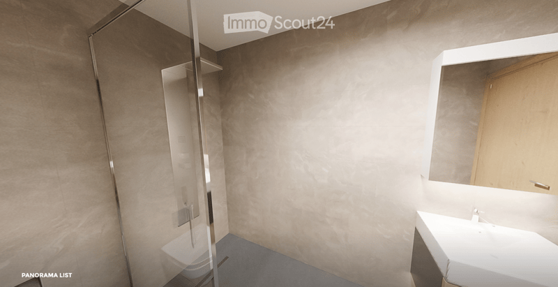 Modern bathroom with a white sink, large mirror, and wooden cabinet. The shower area features a glass enclosure with a sleek, metallic frame.