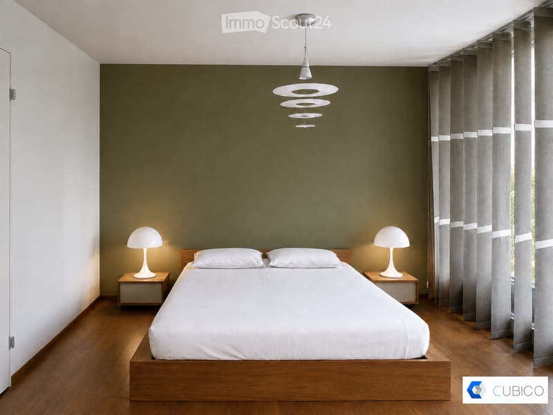 Modern bedroom with a wooden bed, white bedding, two nightstands with lamps, and large windows with grey curtains. The walls are painted in a two-tone design with dark green above and white below.