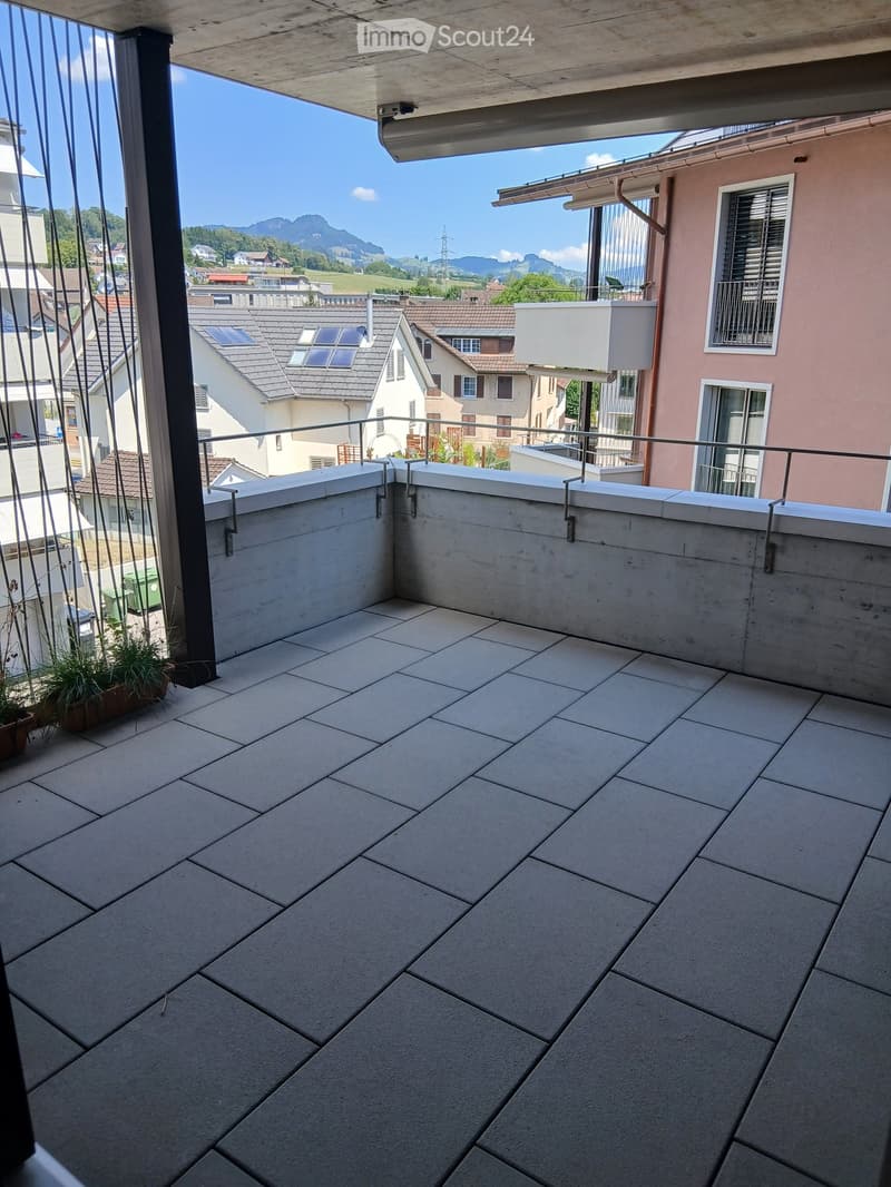 Balcony with tiled floor, metal railing, and scenic mountain view.