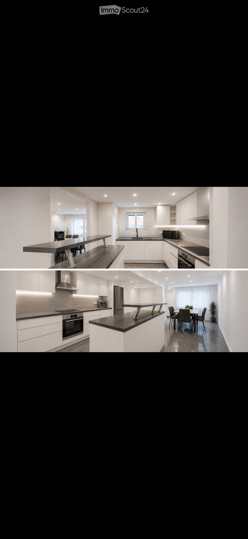 Modern kitchen with white cabinets, black countertops, integrated appliances, and a dining area with a long table and chairs.