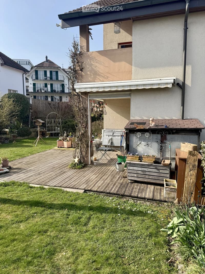 Wooden deck, garden, plants, wooden storage box, awning, garden tools