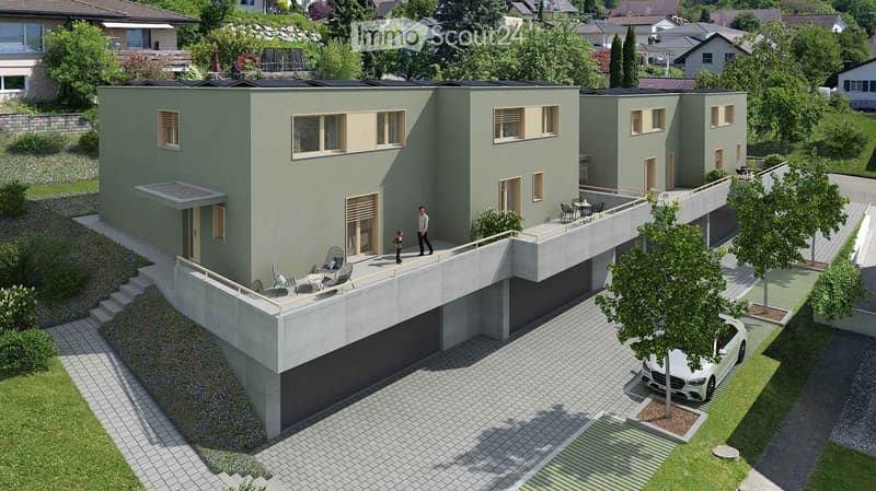 Modern two-story house with green exterior, large windows, garage, and outdoor seating areas.