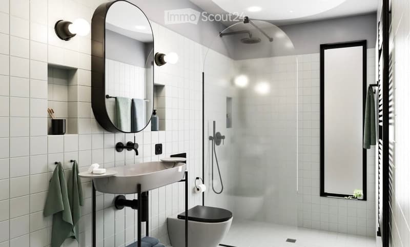 Modern bathroom with white tiled walls, a large oval mirror, a sleek sink, a toilet, and a walk-in shower with a glass enclosure.
