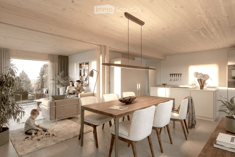 Open-plan living and dining area with a modern aesthetic. Features a light wood dining table with white chairs, a beige sofa, a pendant light, a floor lamp, and a kitchen island with bar stools. A child is playing on a rug with wooden blocks.