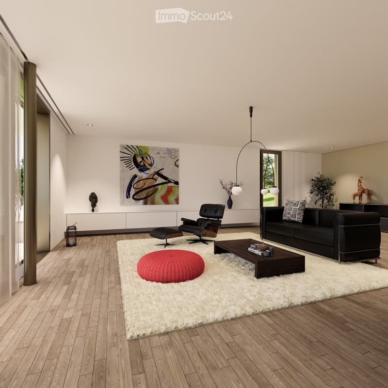 Modern living room with white walls, wooden flooring, and large windows. Features a black sofa, coffee table, red round stool, leather chair, and decorative items including a vase, sculpture, and artwork.