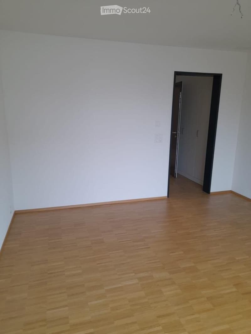 Completely empty room with bare white walls and wooden floor. No furniture or equipment.