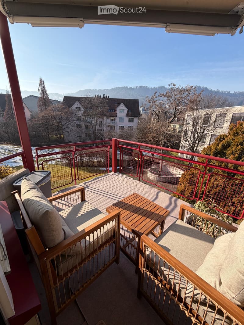 wooden chairs, wooden table, fence, city view