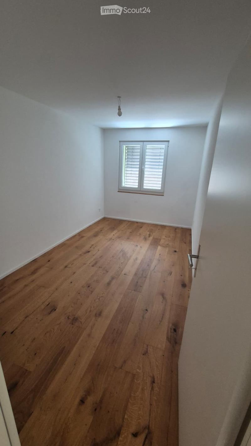 Empty room with wooden flooring, white walls, and a single window with blinds. No furniture or equipment is present.