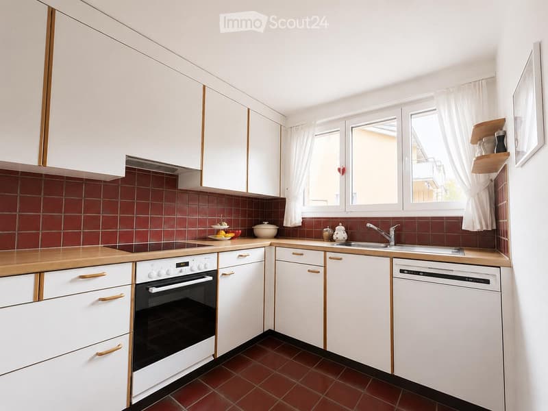 A compact kitchen with white cabinets, wooden countertops, and red tiled backsplash. Features include an oven, dishwasher, sink, and small decorative items on the counter and shelves.