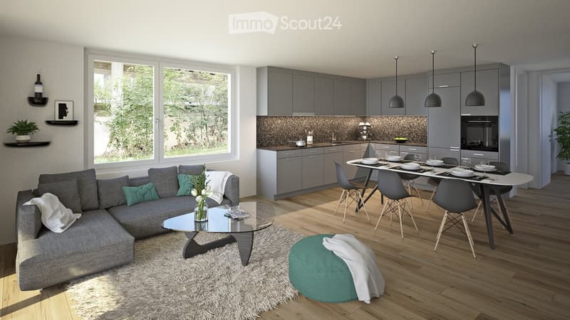 Modern open-plan living and dining area with grey sofa, glass coffee table, dining table with chairs, kitchen cabinets, pendant lights, and a view of greenery outside.