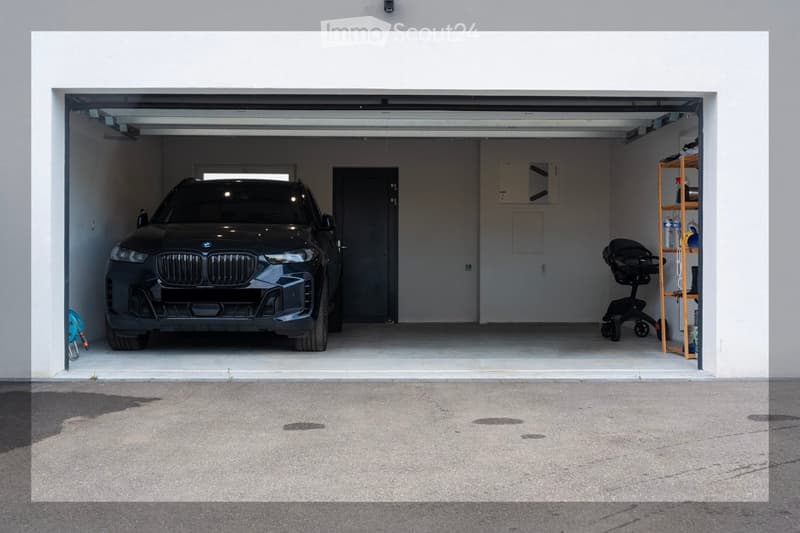 Open garage with a black BMW SUV parked inside, a wooden shelf with various items, and a stroller on the right side.
