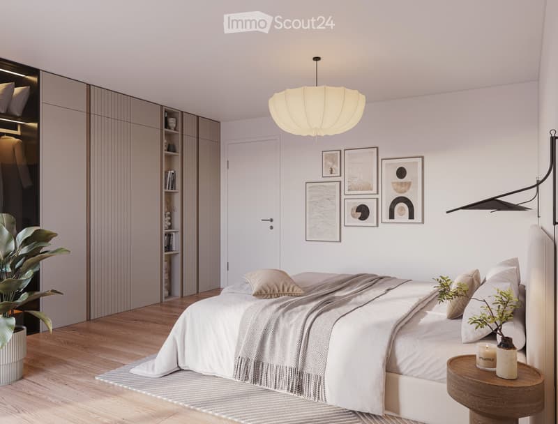 Modern bedroom with a large bed, nightstand, floor lamp, and decorative plant. Features a sleek wardrobe with built-in storage and several picture frames on the wall.