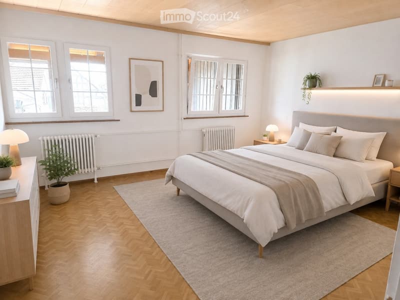 Modern bedroom with a large bed, nightstands, lamps, potted plants, and a picture frame on the wall. The room features wooden flooring and large windows.
