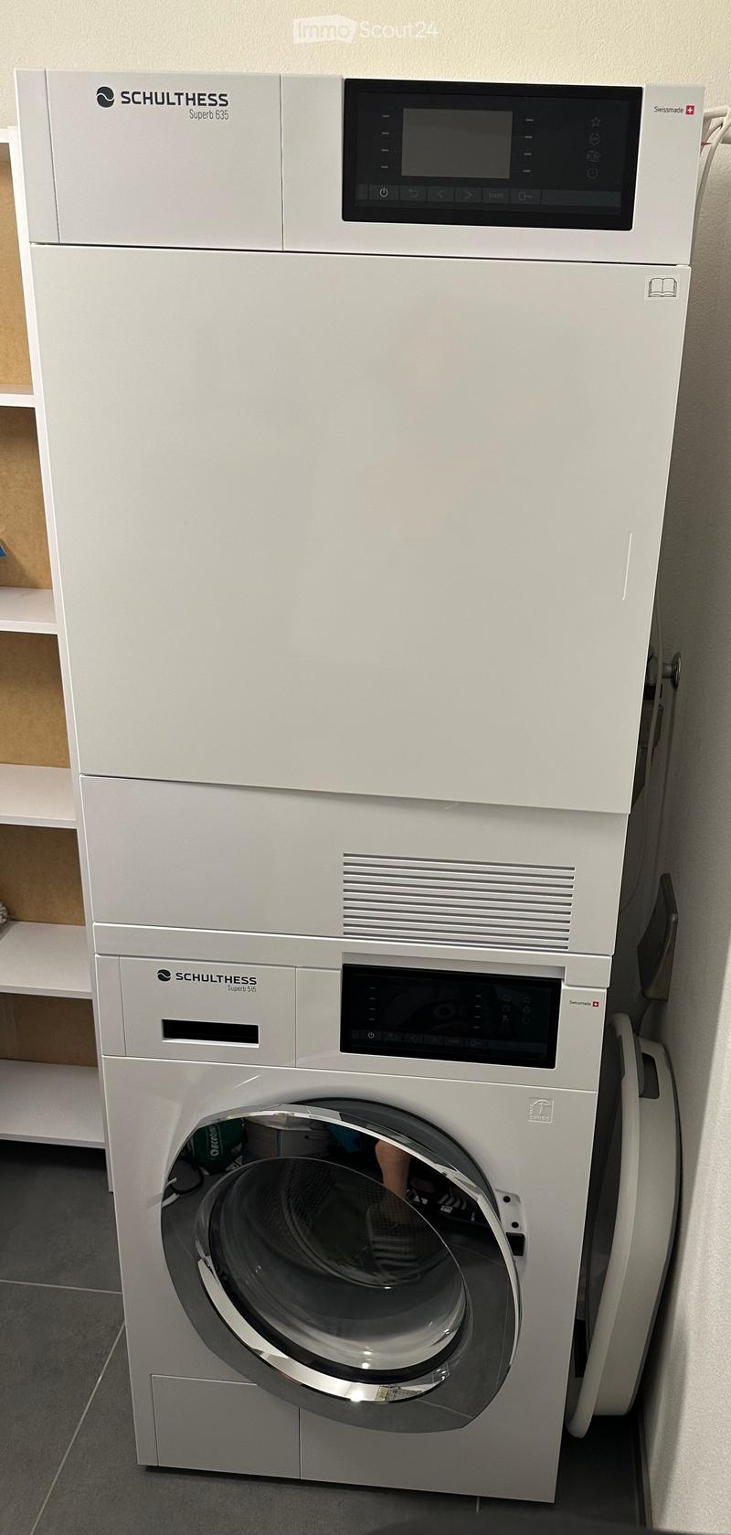 Modern white washing machine and dishwasher unit with digital control panels, sleek design, and stainless steel door.