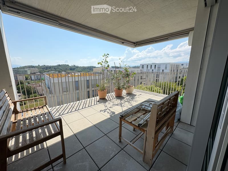 Balcony with tiled floor, wooden bench, chair, and potted plants, overlooking a cityscape with modern buildings and greenery.