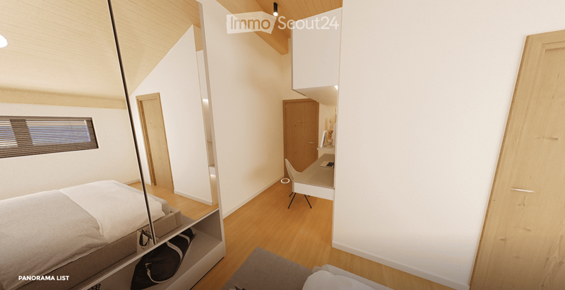 Modern, minimalist bedroom with a large bed, built-in storage, a sleek chair, a mirror, and a small desk area with a chair.