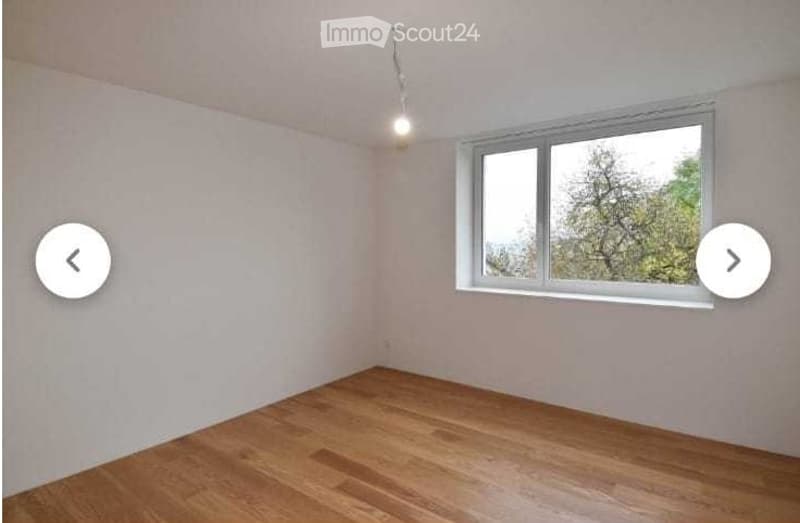 Empty room with light-colored walls, wooden flooring, and a single window with white frame. No furniture or equipment present.