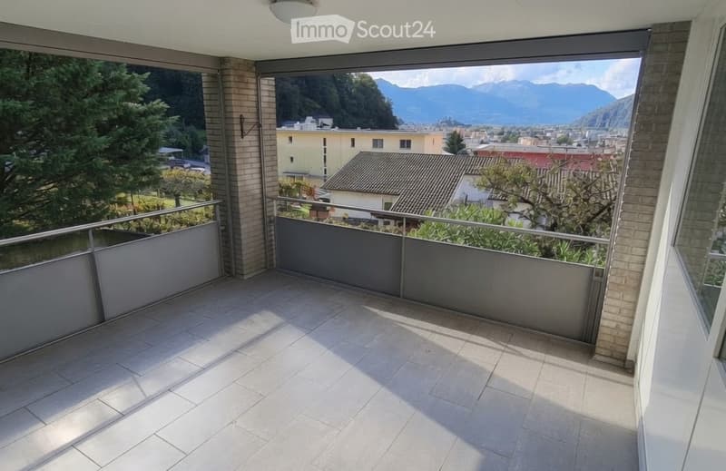 Balcony with tiled floor, metal railing, and scenic mountain view.