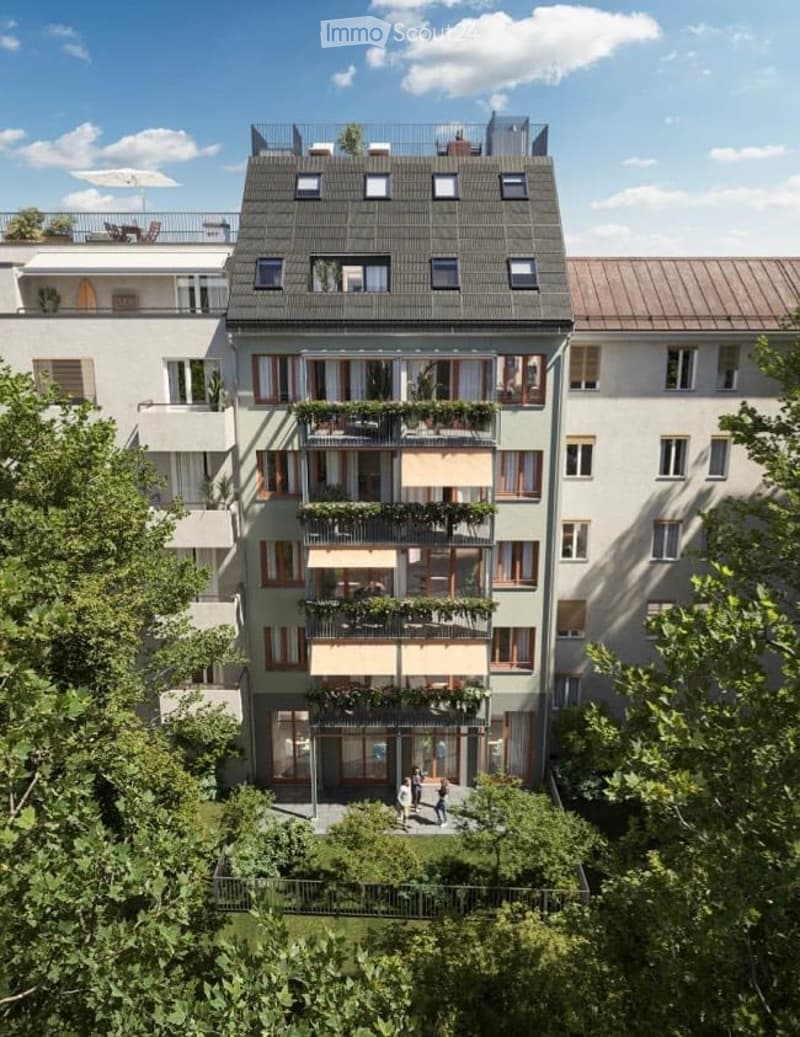 5-story building, numerous balconies, green vegetation, multiple windows, brown roof