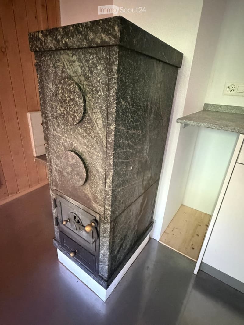 Bathroom with a granite fireplace and a sink visible in the background.