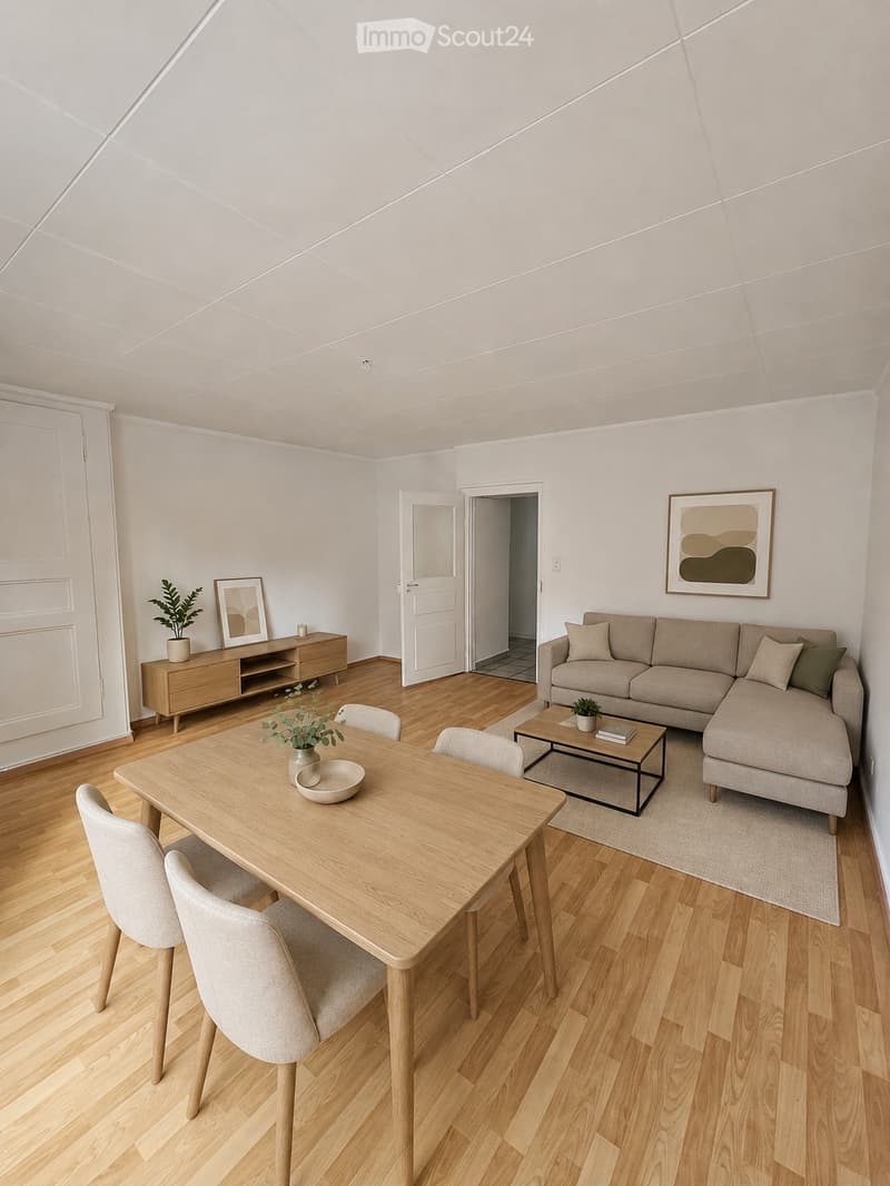 Bright, modern living and dining area with light wood flooring, a sectional sofa, coffee table, dining table with chairs, sideboard, and decorative plants.
