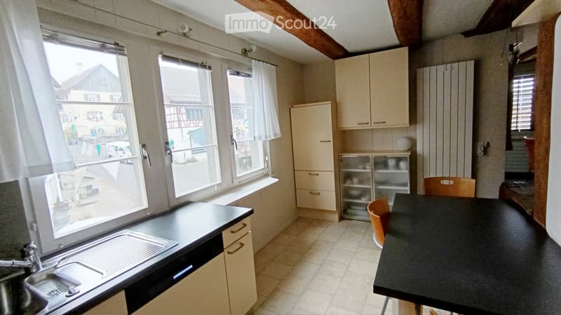 kitchen with sink, tiled floor, cabinets, windows, dishwasher, countertop, dining table, chairs, faucet