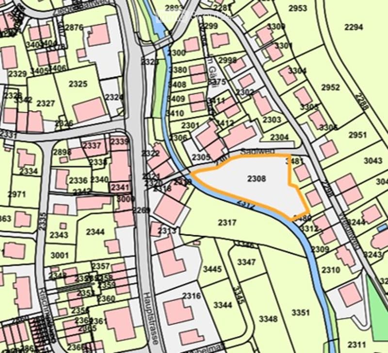 Topographic map showing a neighborhood with streets, buildings, and numbered plots.