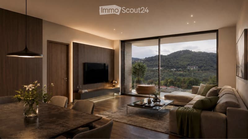 Modern living room with large windows offering a scenic mountain view, featuring a sectional sofa, coffee table, dining table with chairs, and decorative elements.