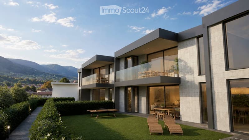 Modern two-story house with large windows, balconies, and a scenic mountain view. The house features a well-maintained lawn, outdoor seating, and a raised ground floor.