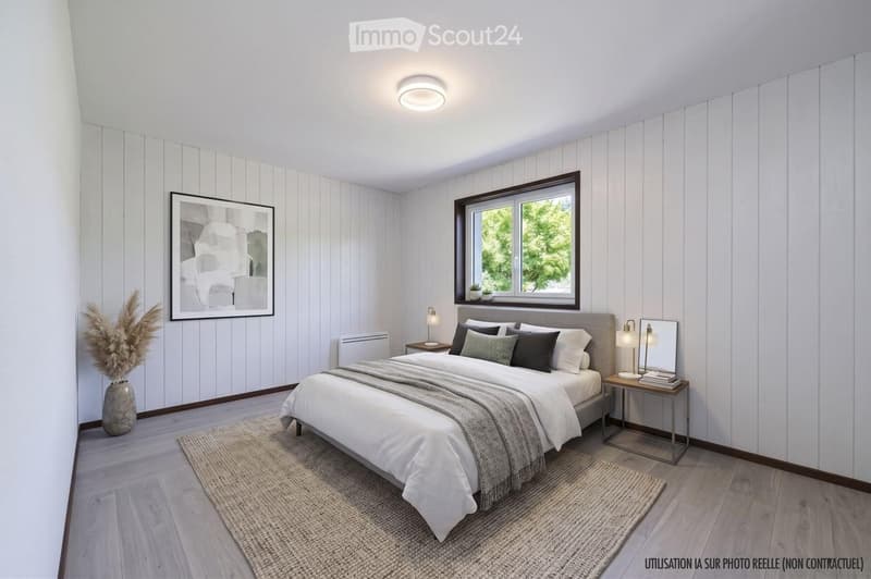 Modern bedroom with white shiplap walls, wooden flooring, large window, bed with multiple pillows and blankets, nightstand with lamp, decorative vase, and artwork on the wall.