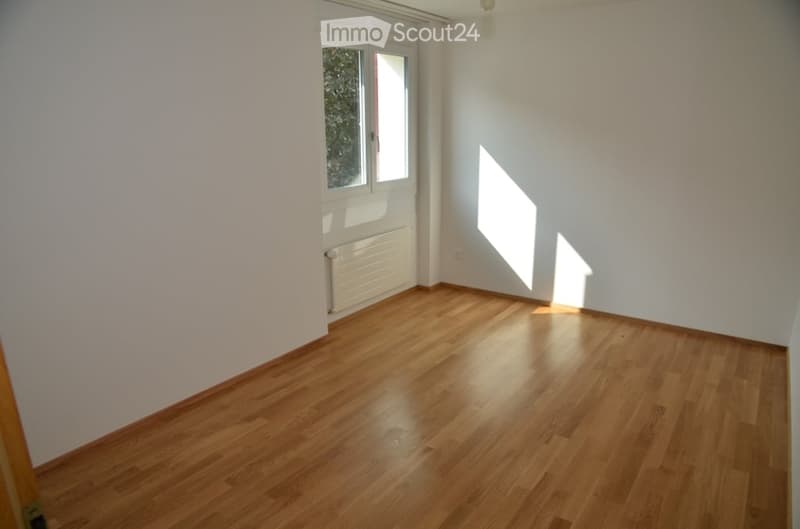 Completely empty room with bare white walls and wooden floor. No furniture or equipment.