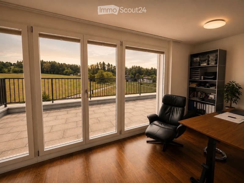 Bright room with large glass doors opening to a balcony, wooden floor, leather chair, desk, bookshelf, and potted plant.