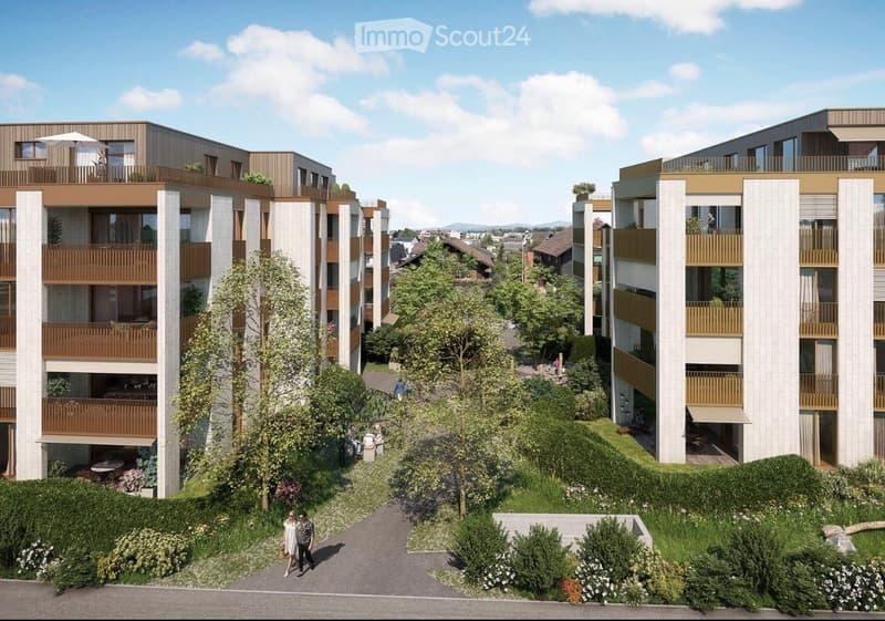 Modern multi-story residential building with balconies, surrounded by greenery and pathways.