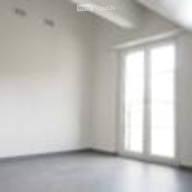 Completely empty room with white walls, wooden floor, and large windows with blinds.