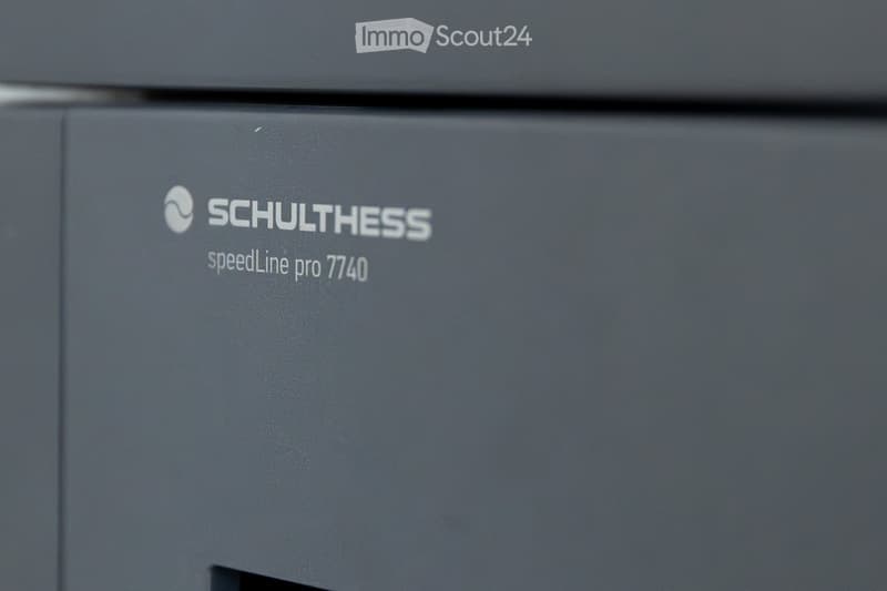 Close-up of a grey Schulthess speedLine pro 7740 appliance, likely a washing machine or dryer, with branding and model name visible.