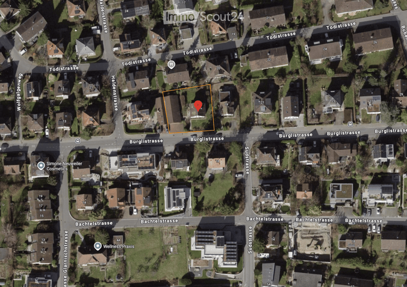 Aerial view of a residential area with multiple houses, numbered addresses, and surrounding streets.