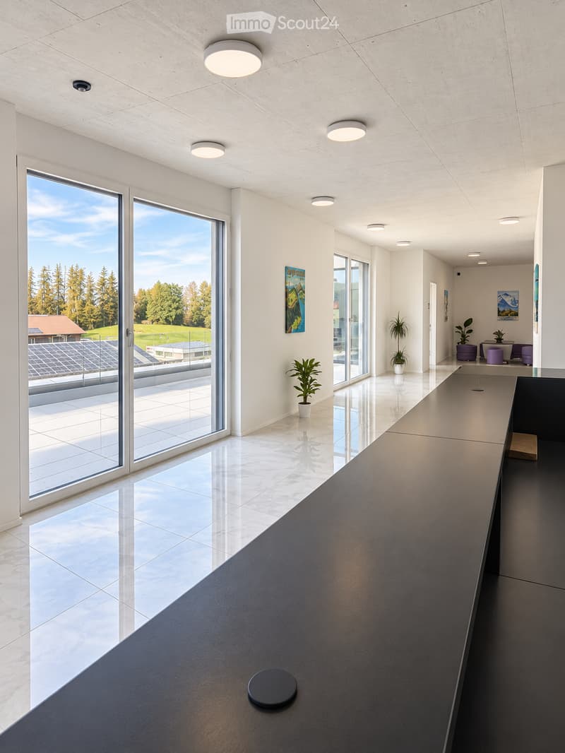 Modern, minimalist hallway with large glass windows, polished marble floors, recessed lighting, and a sleek black table with a stool. Potted plants and artworks adorn the walls.