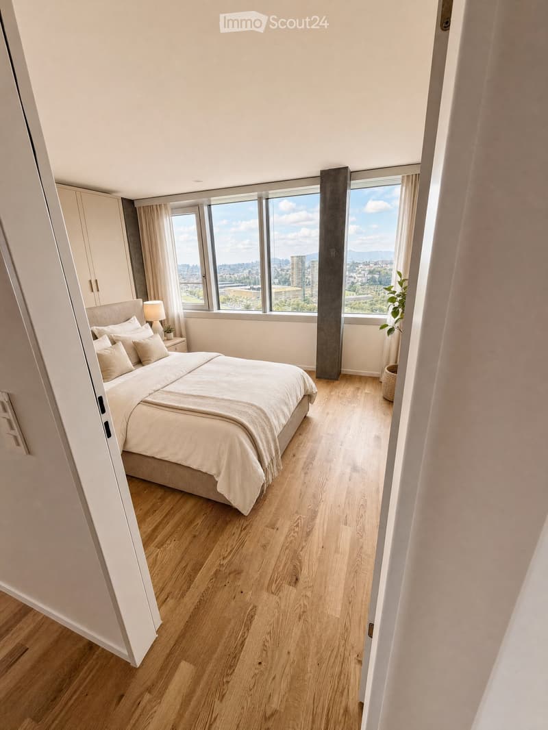 Modern bedroom with a large bed, nightstand, lamp, and plant, featuring wooden flooring and large windows with a city view.