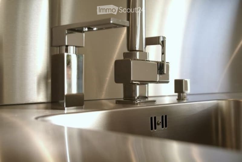 Modern bathroom sink with sleek, chrome faucet and minimalist design.