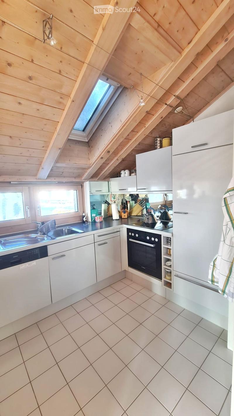 Modern kitchen with white cabinets, stainless steel appliances, and a tiled floor. Features include a refrigerator, oven, dishwasher, sink, and various kitchen utensils.