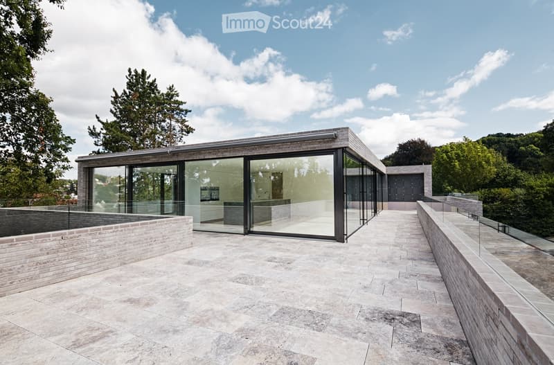 modern house, glass walls, open terrace, raised ground floor, brick walls