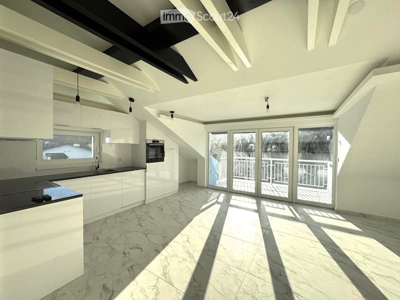 Modern kitchen with white cabinets, marble flooring, and large windows leading to a balcony.
