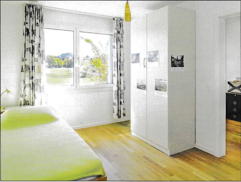 Empty room with white walls, wooden flooring, large windows with sheer curtains, and a view of greenery outside.